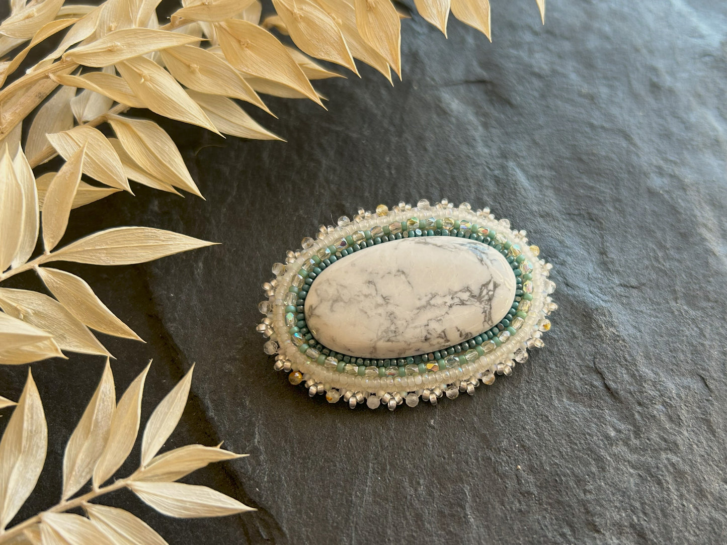 Howlite brooch with rutilated quartz