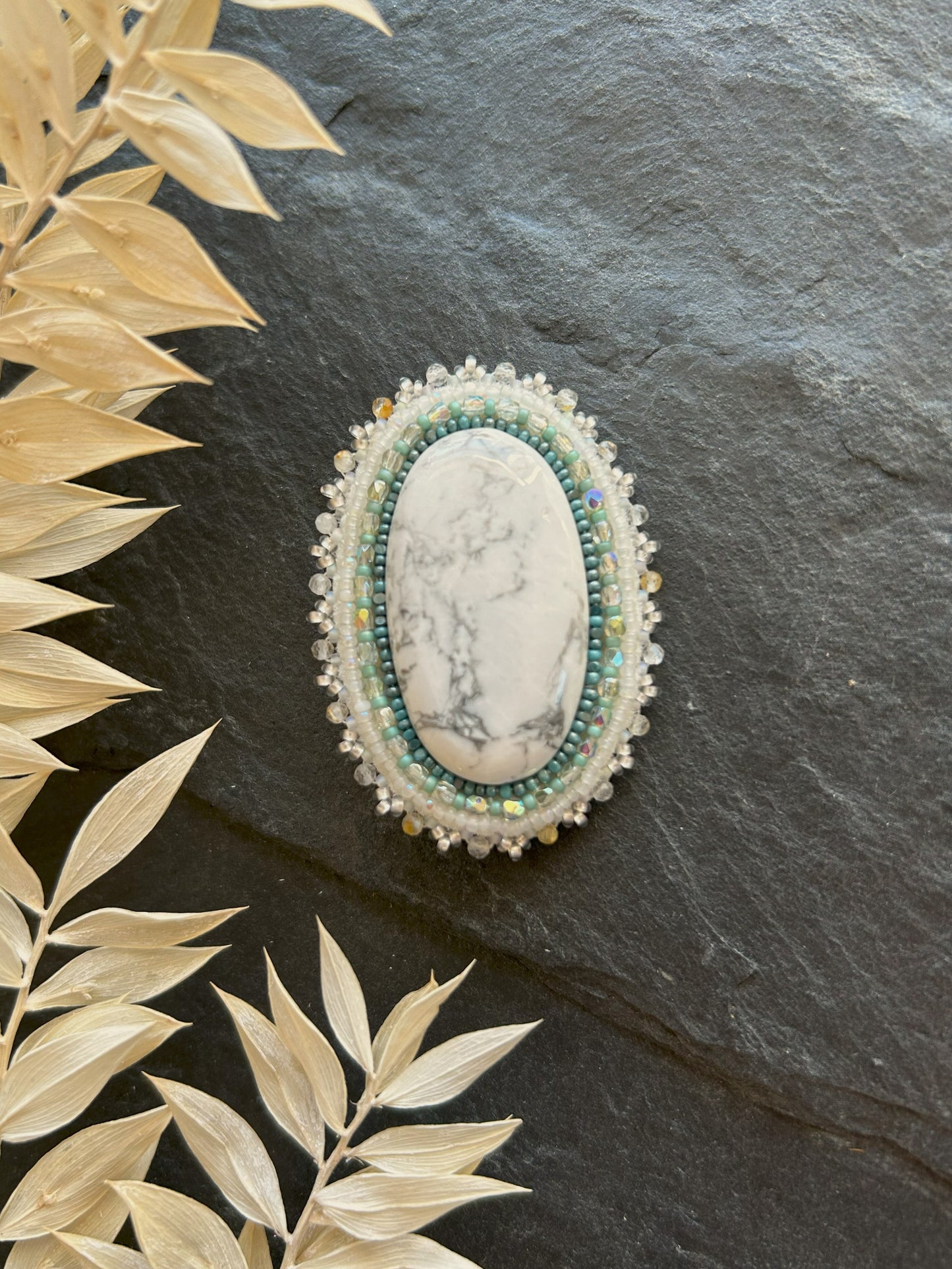 Howlite brooch with rutilated quartz