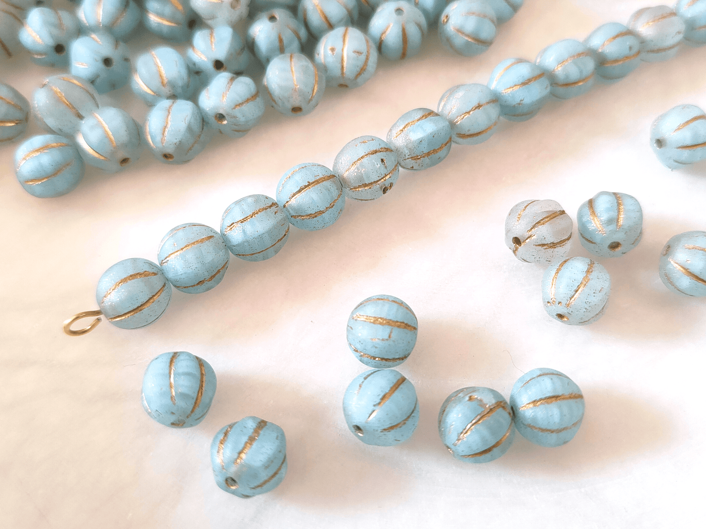 Melon beads 8mm - colorless, light blue & gold