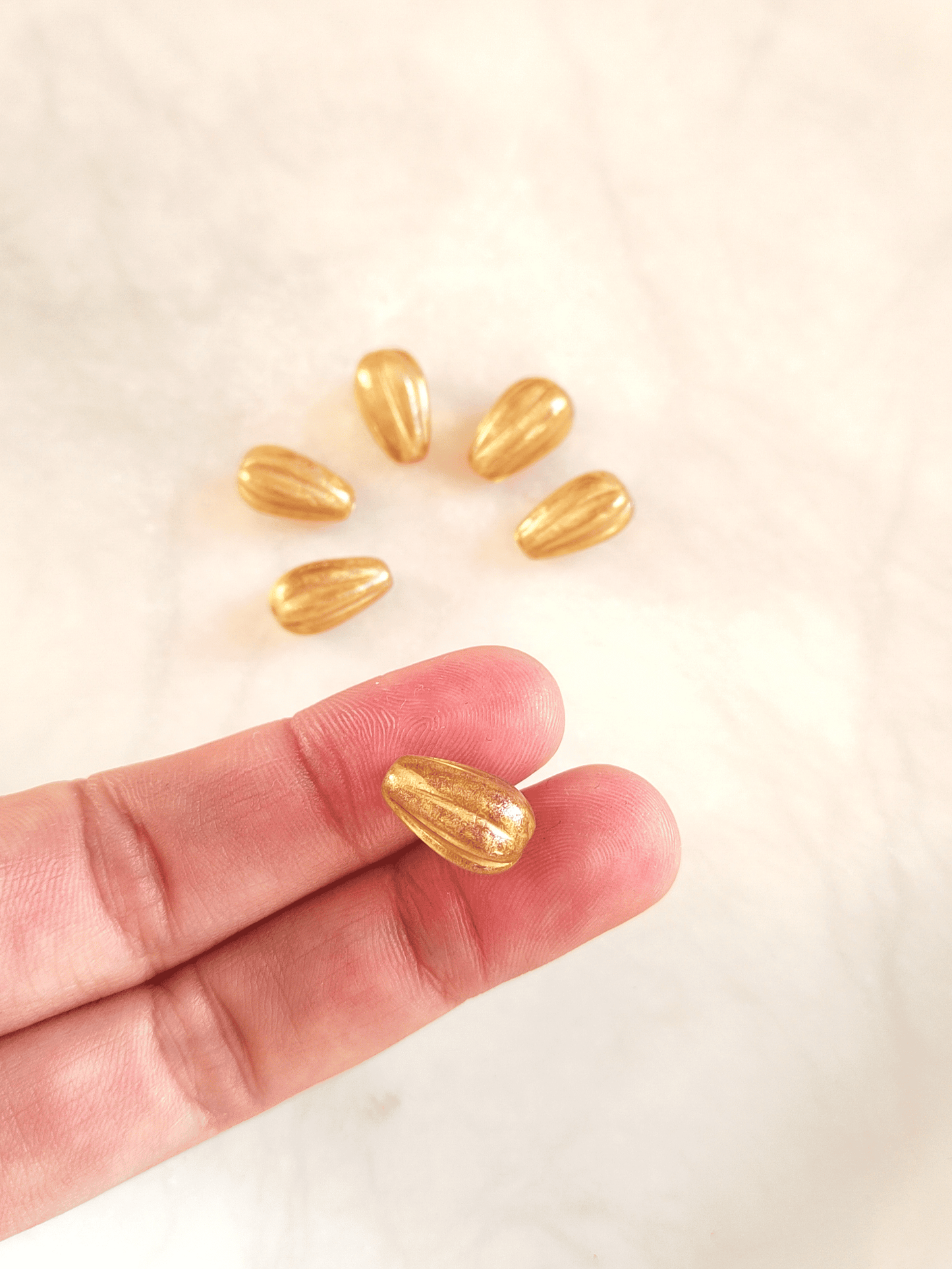 Melon drop beads 13x8mm - colorless & gold shimmer