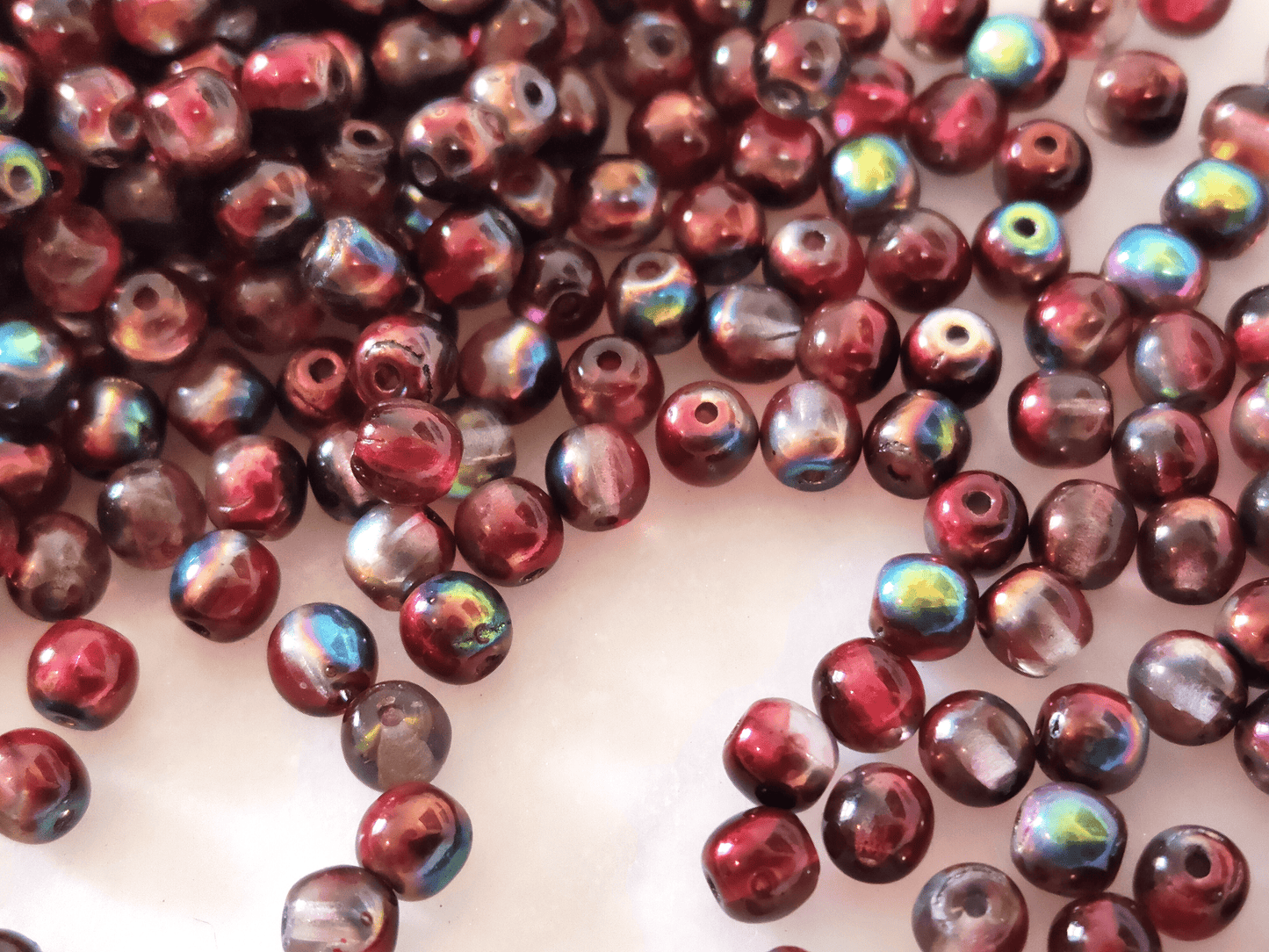 4mm round beads - colorless & metallic red