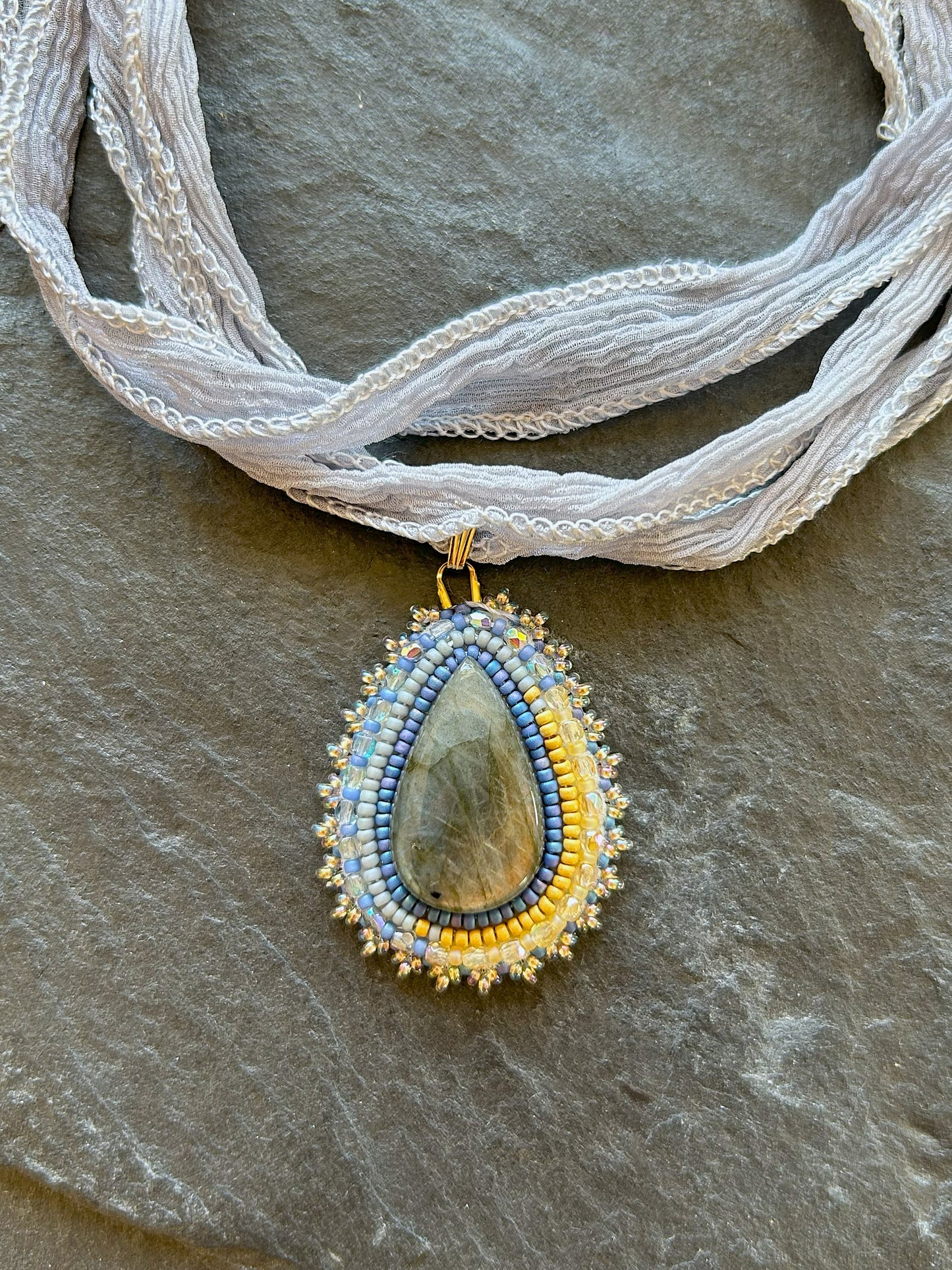 Small labradorite necklace pendant with blue to yellow fire