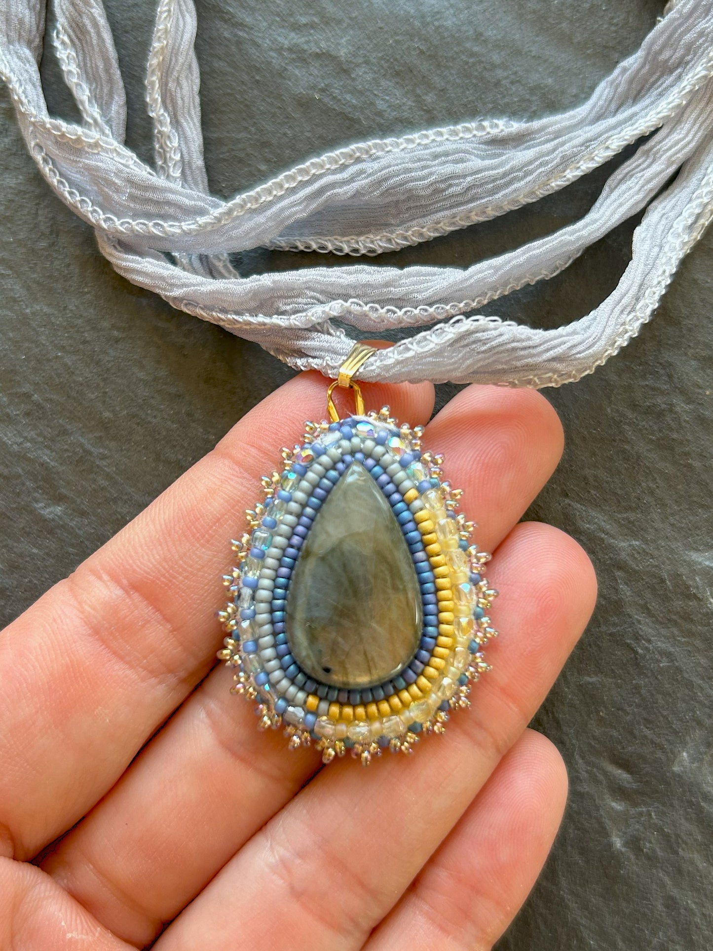 Small labradorite necklace pendant with blue to yellow fire