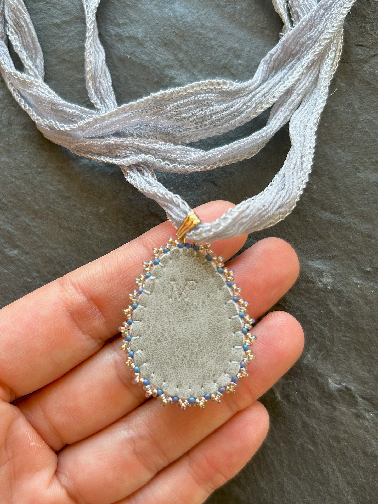 Small labradorite necklace pendant with blue to yellow fire