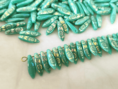 Dagger beads 5x16mm - turquoise & iris spiral motif