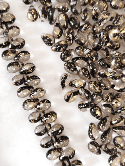 Drop beads 6x9mm - colorless, dark purple & golden speckles