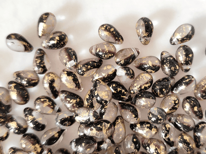 Drop beads 6x9mm - colorless, dark purple & golden speckles