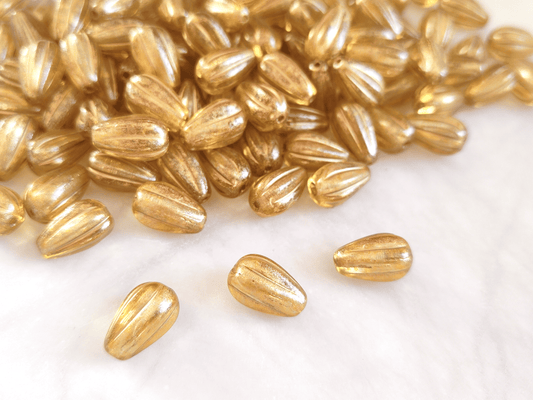 Melon drop beads 13x8mm - colorless & gold shimmer